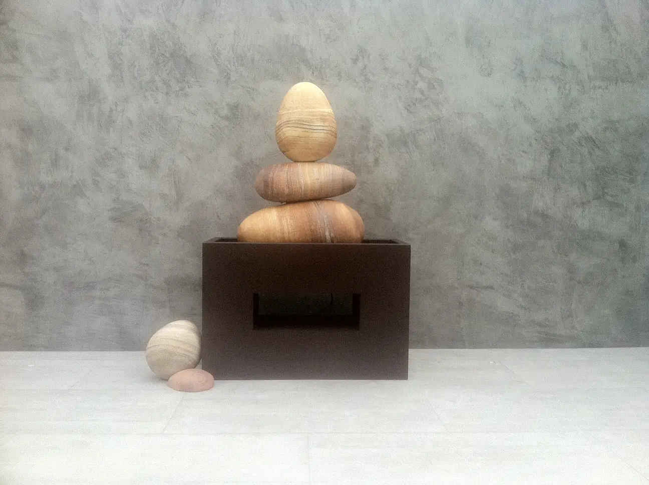 A wooden stack of rocks on top of a box.